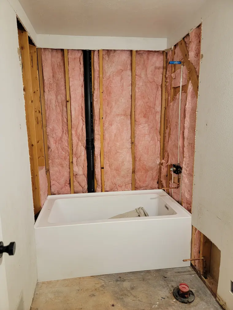 New alcove tub set into a framed and insulated wall