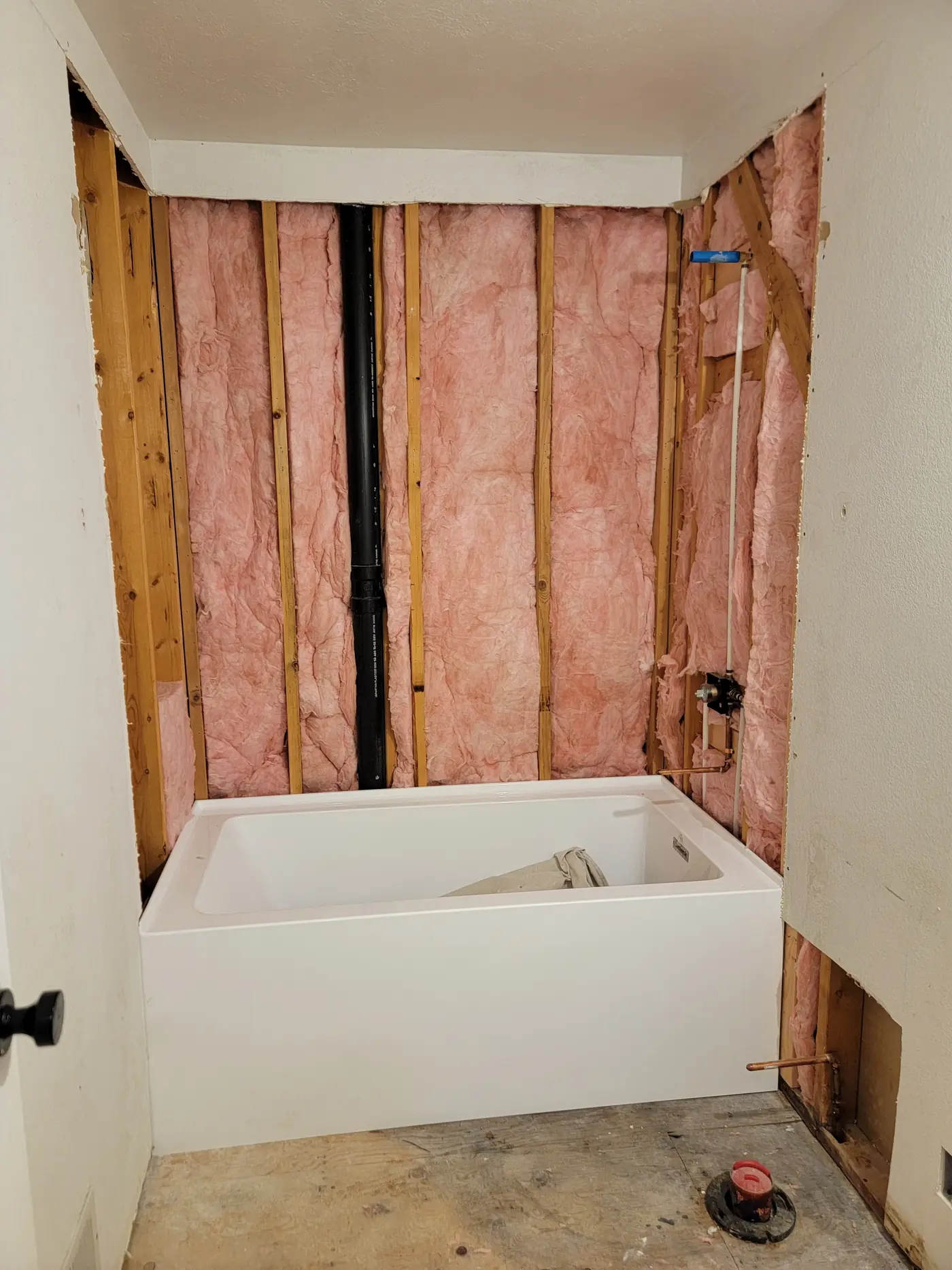 New alcove tub set and levelled into a freshly insulated wall