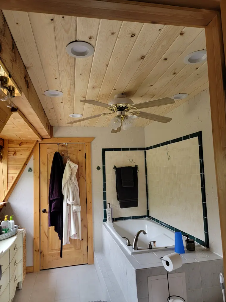 Bathroom with a new knotty pine plank ceiling and recessed lights