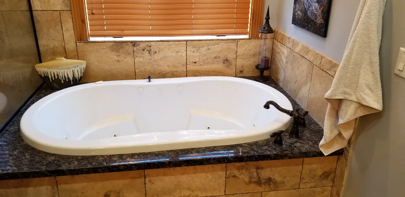 Before — the jetted tub and granite deck